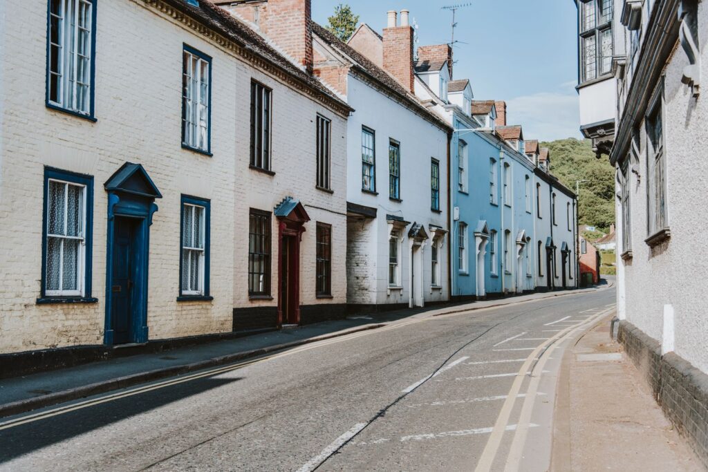 Row of painted cottages on a sloping street