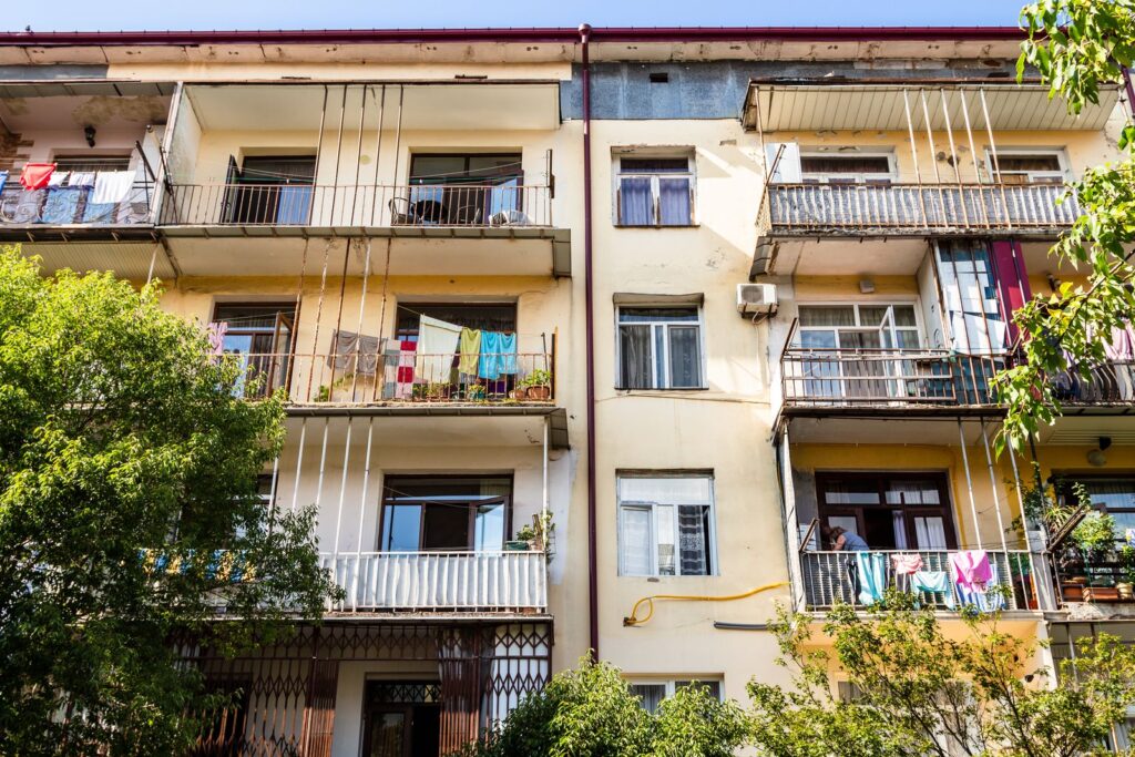 Apartment building with balconies and plants