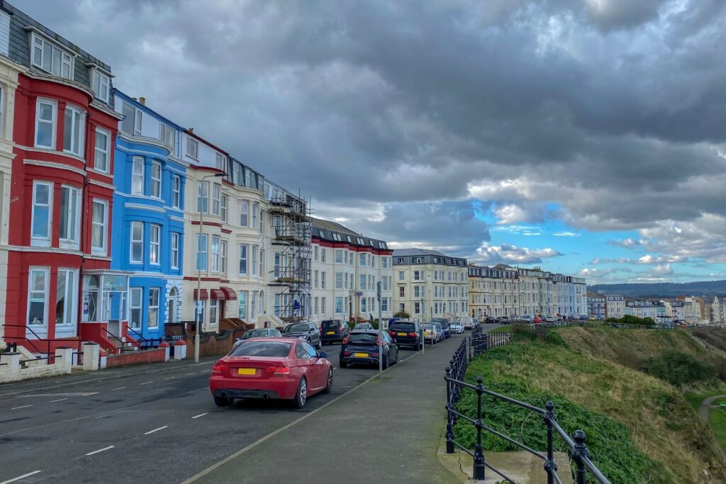 Row of brightly painted terraced houses on a hillside street