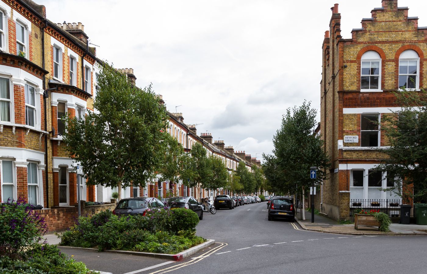 A quiet residential street of brick terraced houses